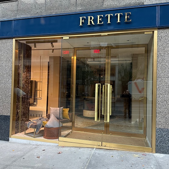 storefront with glass and gold hardware doors