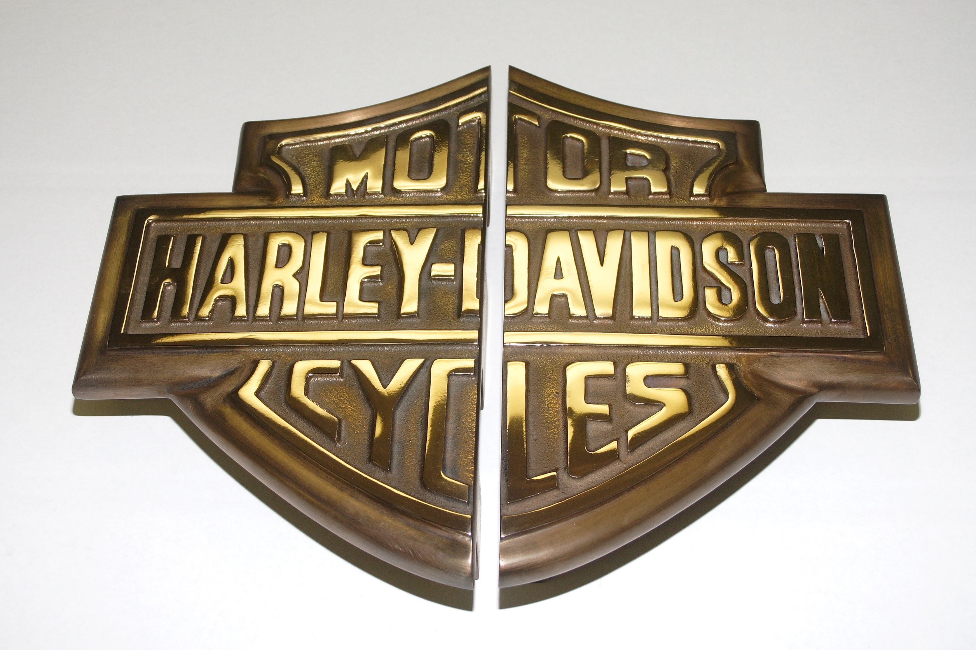 gold metal Harley Davidson sign