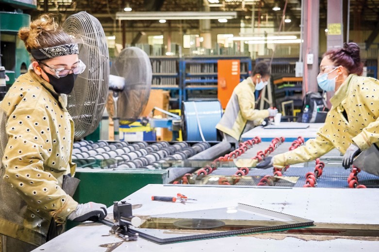 three women working on fenestration line