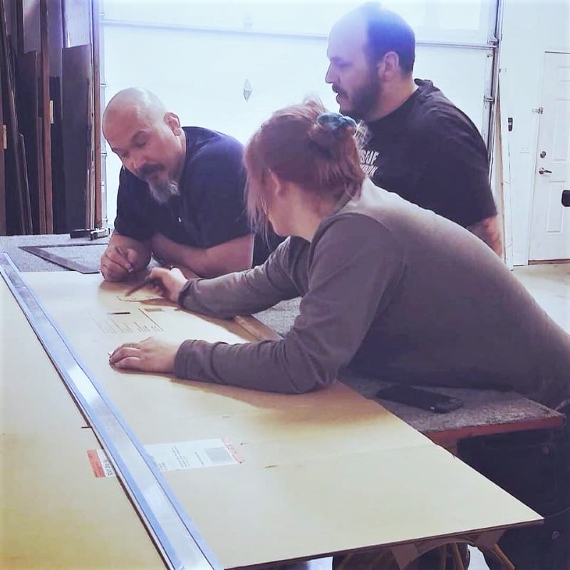 three office workers discuss building plans