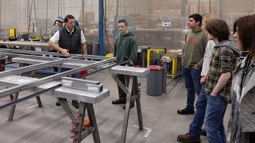 students look at manufacturing facility on a tour