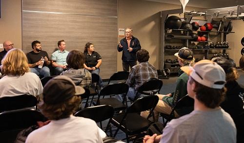students listen to government officials during facility tour
